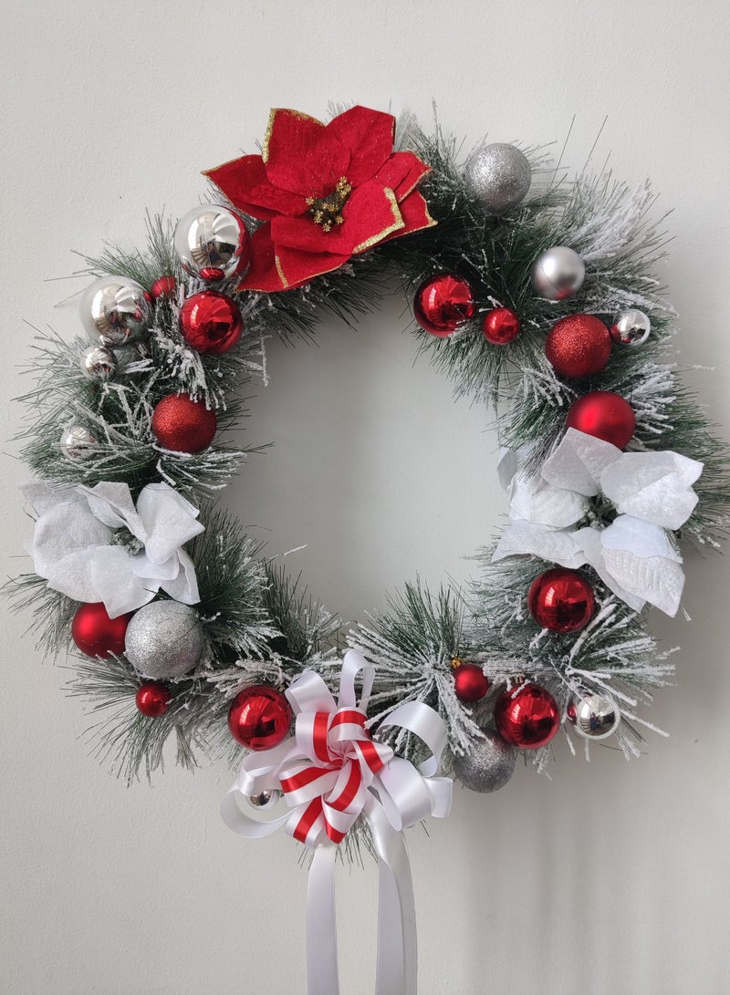 Artificial wreath with poinsettia flowers