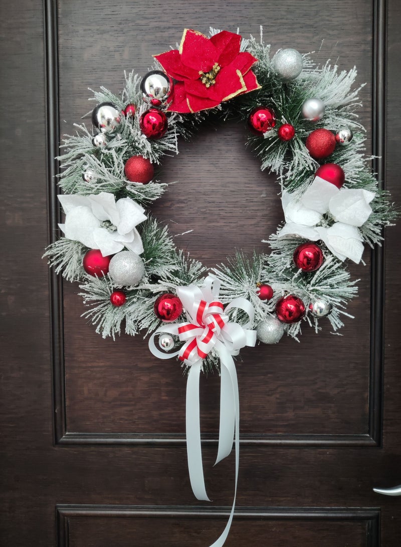 Artificial wreath with poinsettia flowers