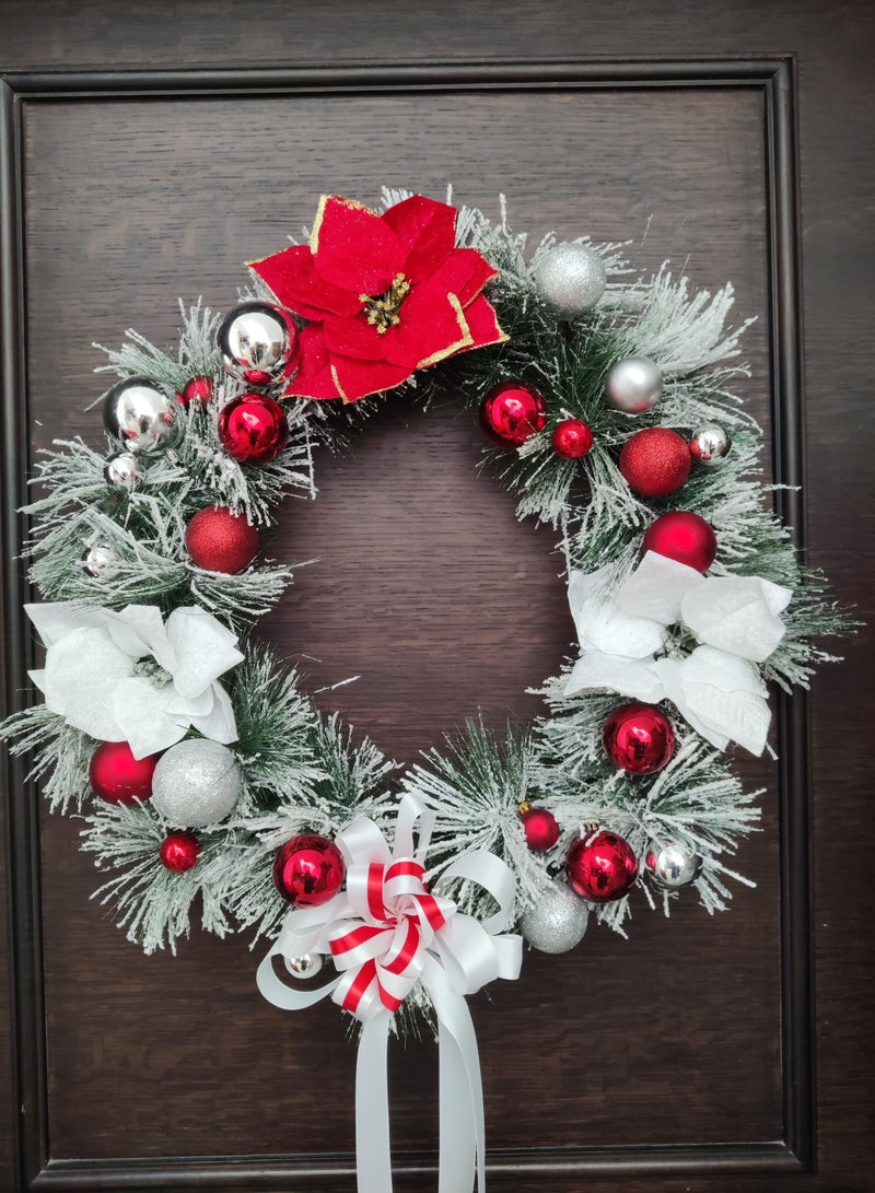 Artificial wreath with poinsettia flowers