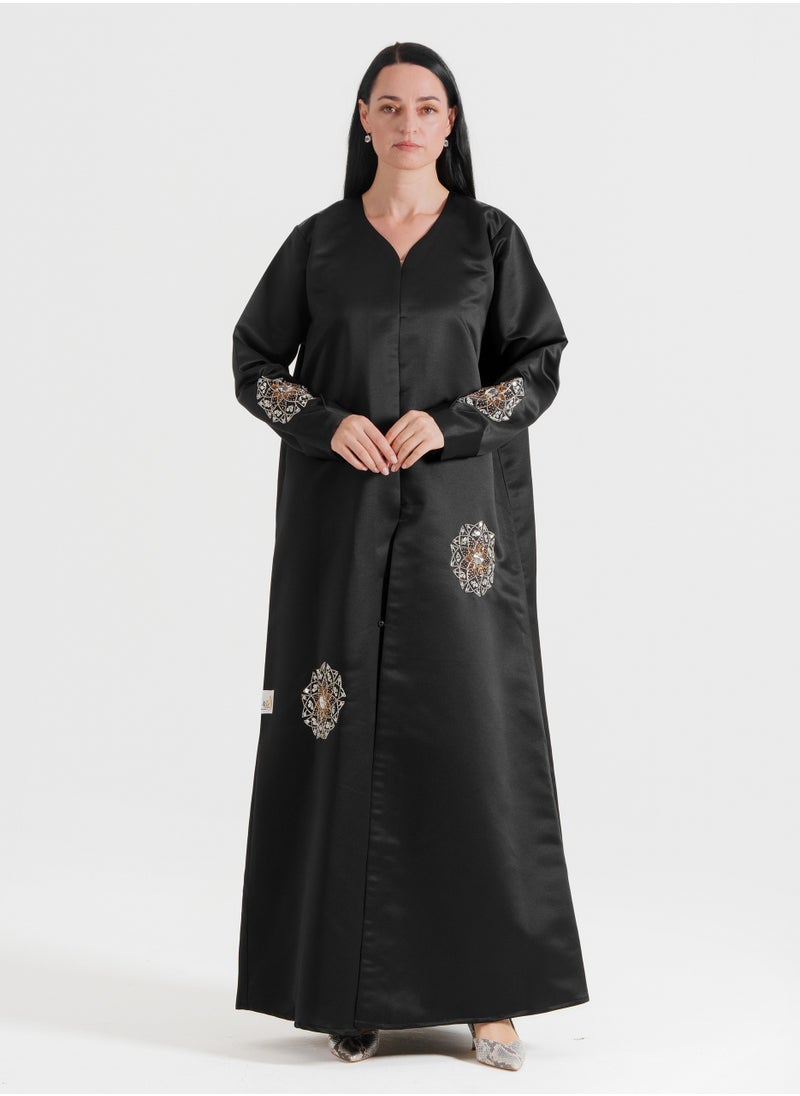 A luxurious abaya featuring silver Arabic-inspired hand embroidery