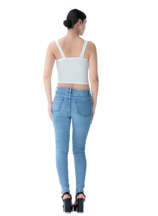 Trendy white crop top with a unique cross-back design, perfect for summer wear.