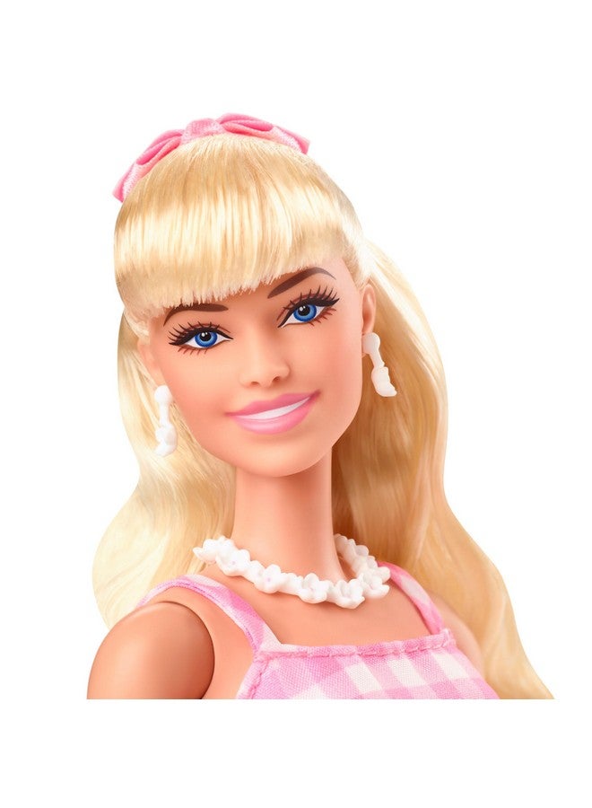 The Movie Doll Wearing Pink And White Gingham Dress With Daisy Chain Necklace