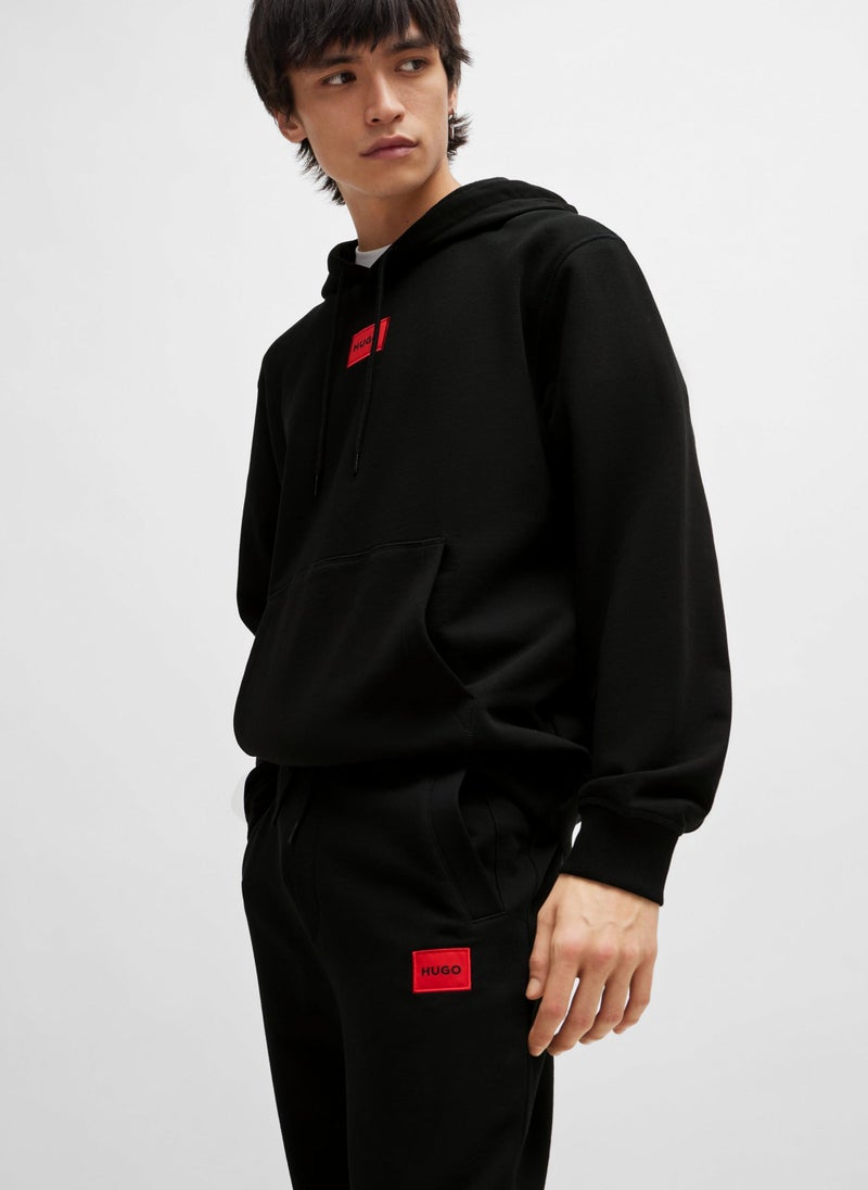 Cotton-terry tracksuit bottoms with red logo label