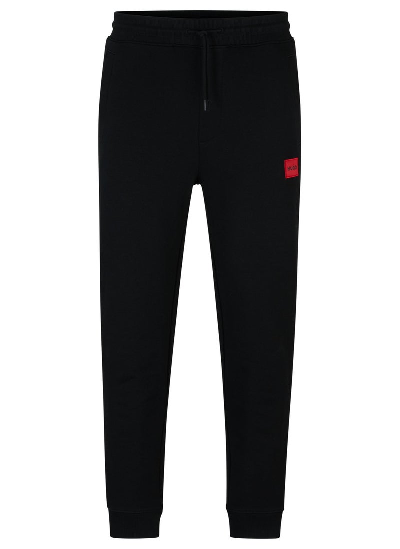 Cotton-terry tracksuit bottoms with red logo label