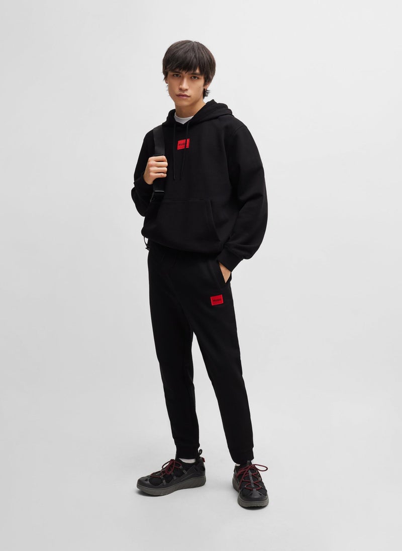 Cotton-terry tracksuit bottoms with red logo label