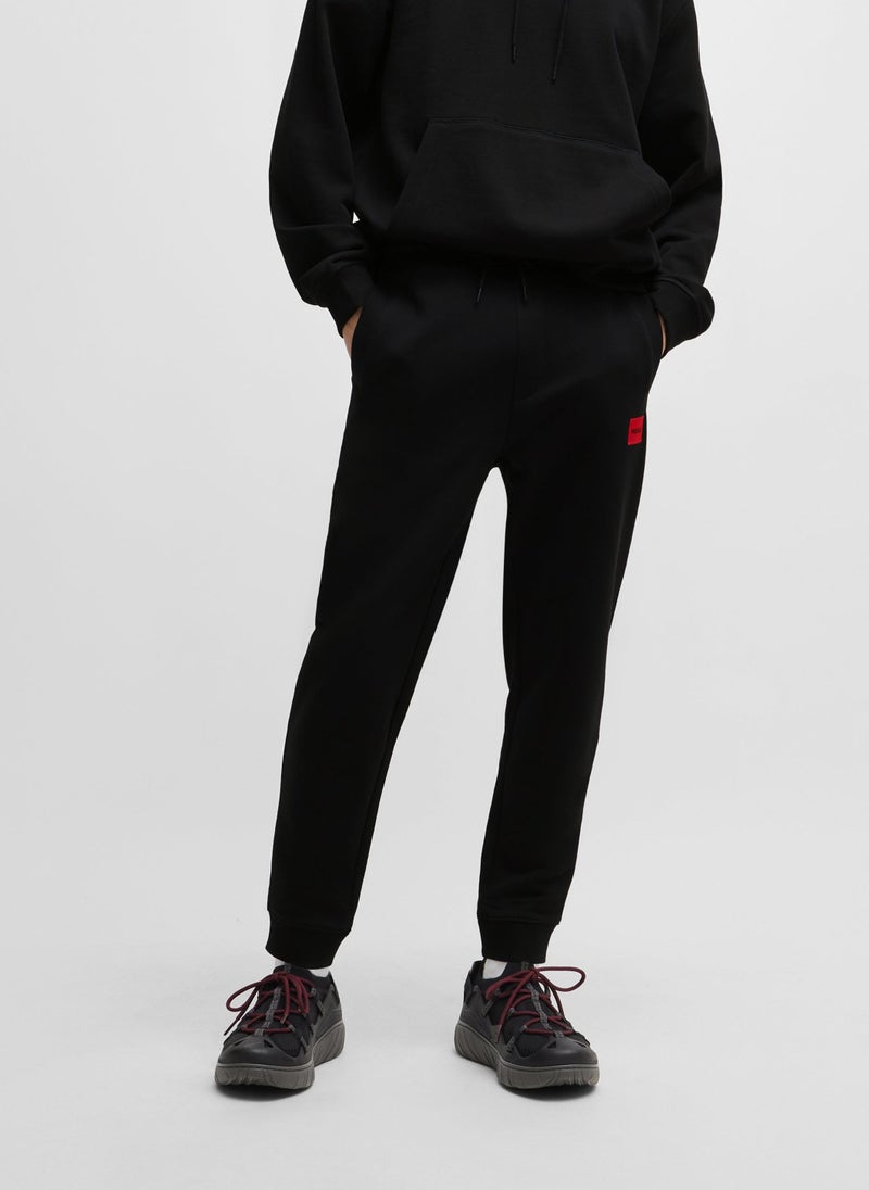 Cotton-terry tracksuit bottoms with red logo label