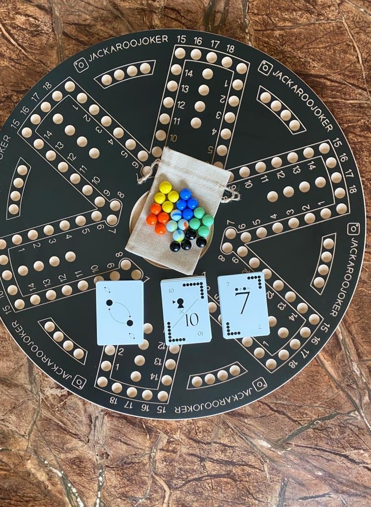 Jackaroo board game with two sides for 4 and 6 players with glass marbles, playing cards and bag.