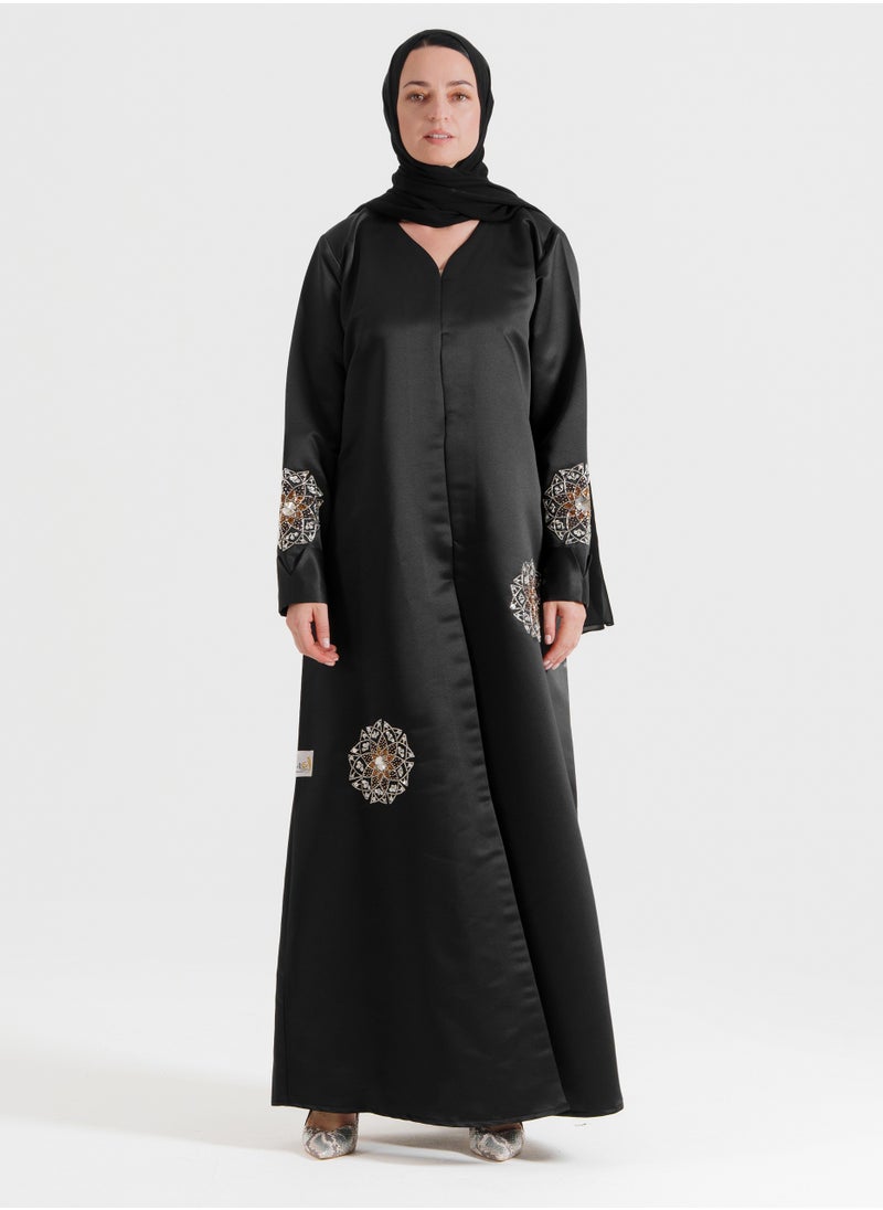 A luxurious abaya featuring silver Arabic-inspired hand embroidery