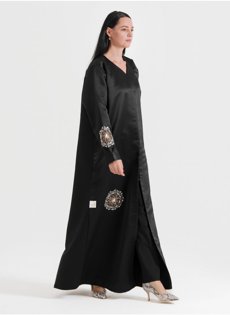 A luxurious abaya featuring silver Arabic-inspired hand embroidery