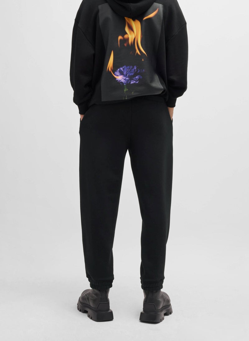 Relaxed-fit tracksuit bottoms with logo and slogans