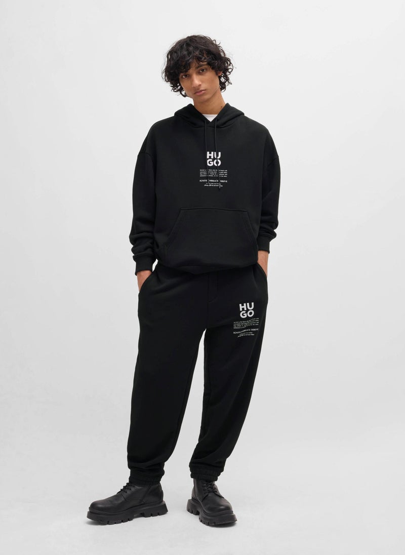 Relaxed-fit tracksuit bottoms with logo and slogans