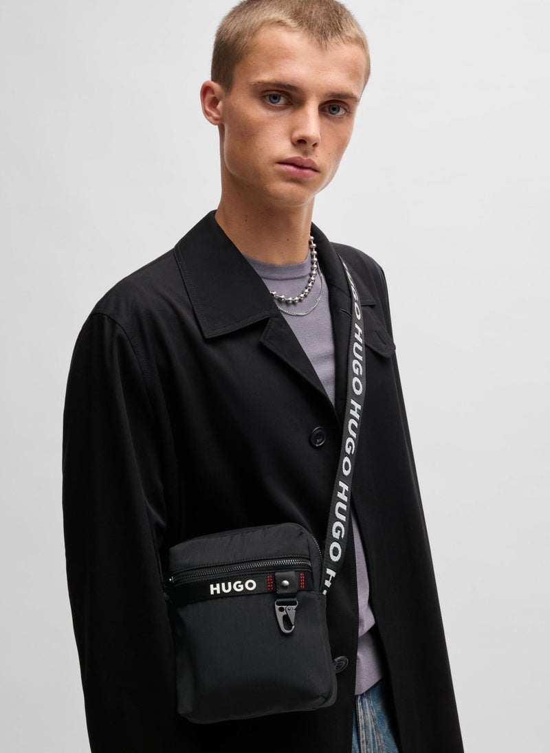 Reporter bag with branded adjustable strap and zip closure