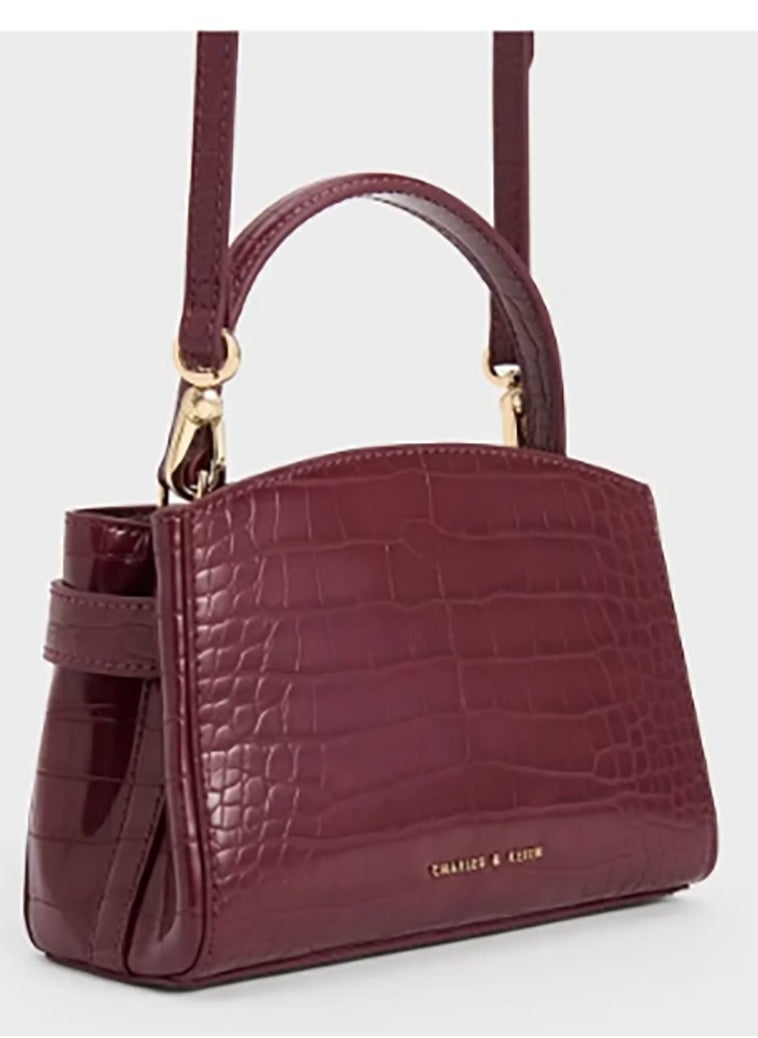 A shoulder - carry tote bag from Charles & Keith accentuated by a strap with a metal buckle.