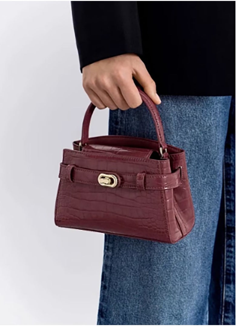 A shoulder - carry tote bag from Charles & Keith accentuated by a strap with a metal buckle.