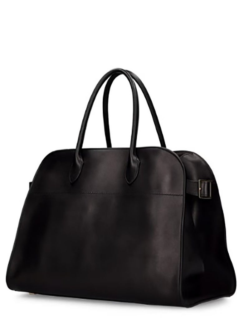 The top - handle bag named Margaux 10, crafted from plain leather, is from The Row.