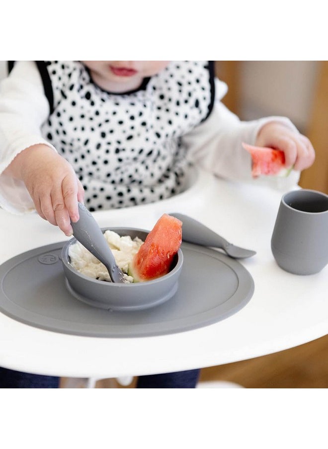 ezpz First Food Set - 100% Food Grade Silicone Suction Bowl with Built-in Placemat, Training Cup & Spoon - Designed by a Pediatric Feeding Specialist - Promotes Self Feeding - 6 Months+ (Grey)