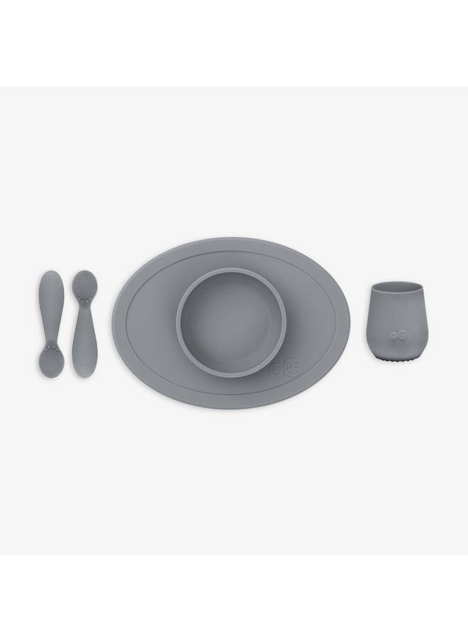 ezpz First Food Set - 100% Food Grade Silicone Suction Bowl with Built-in Placemat, Training Cup & Spoon - Designed by a Pediatric Feeding Specialist - Promotes Self Feeding - 6 Months+ (Grey)