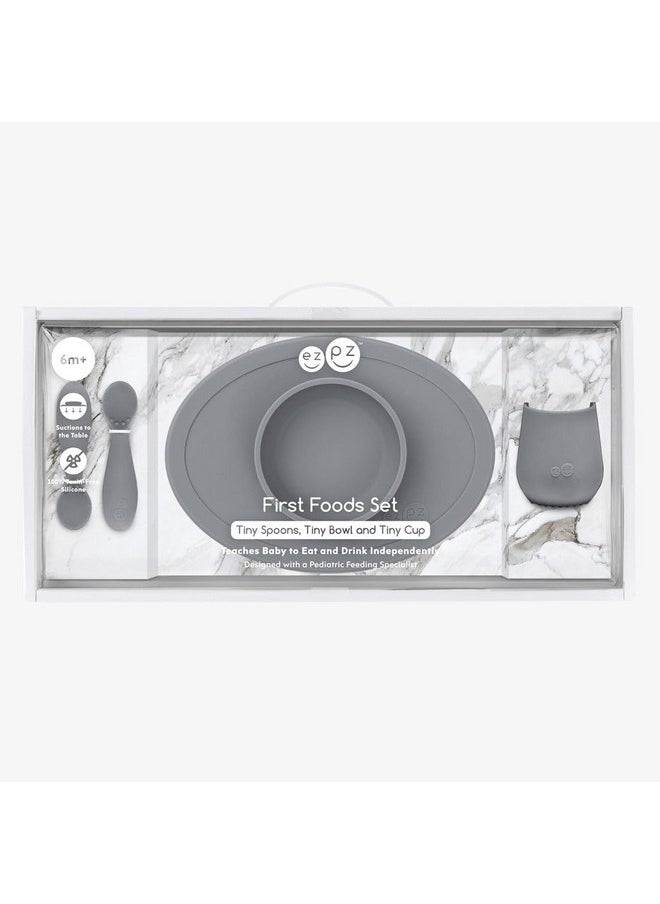 ezpz First Food Set - 100% Food Grade Silicone Suction Bowl with Built-in Placemat, Training Cup & Spoon - Designed by a Pediatric Feeding Specialist - Promotes Self Feeding - 6 Months+ (Grey)