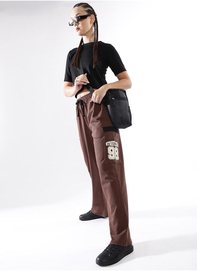 Women Track Pants in Brown featuring Jogger fit with a printed pattern, no sleeves, regular length, secured with elasicated + drawstring closure, crafted from terry – an essential addition to your stylish collection.