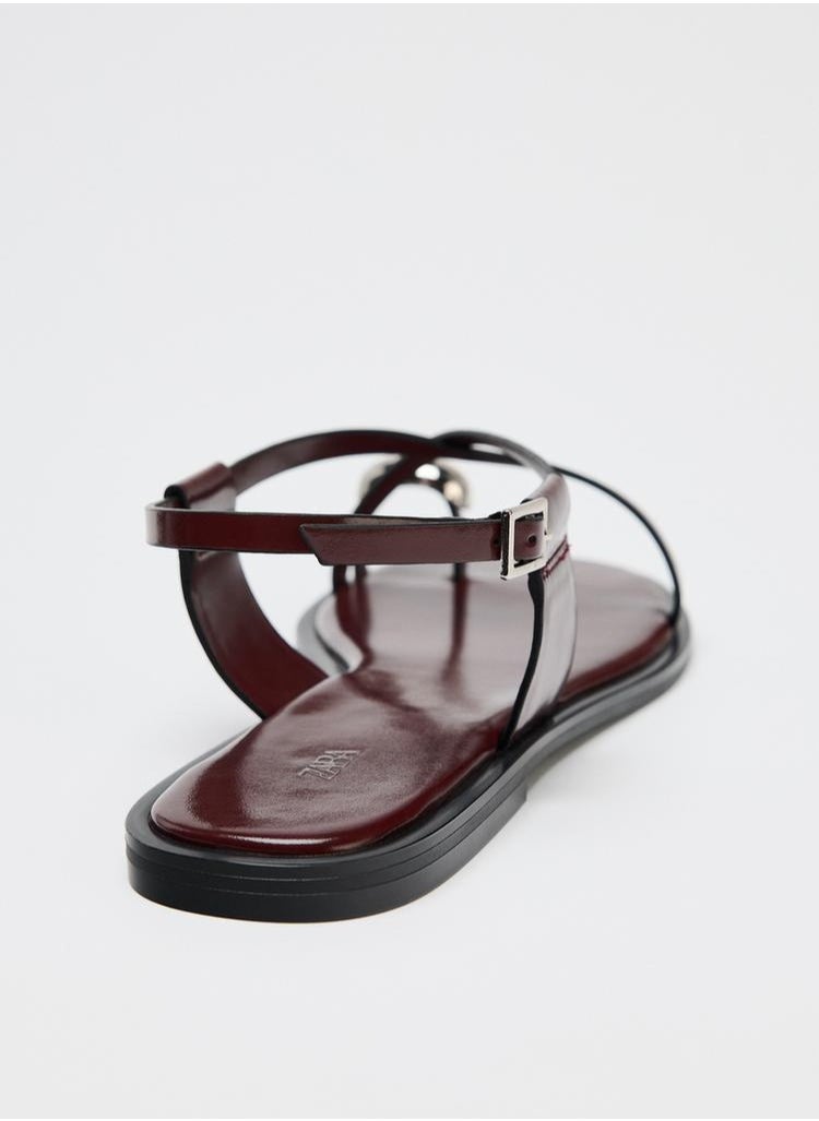 Strappy flat slider sandals with metal embellishment