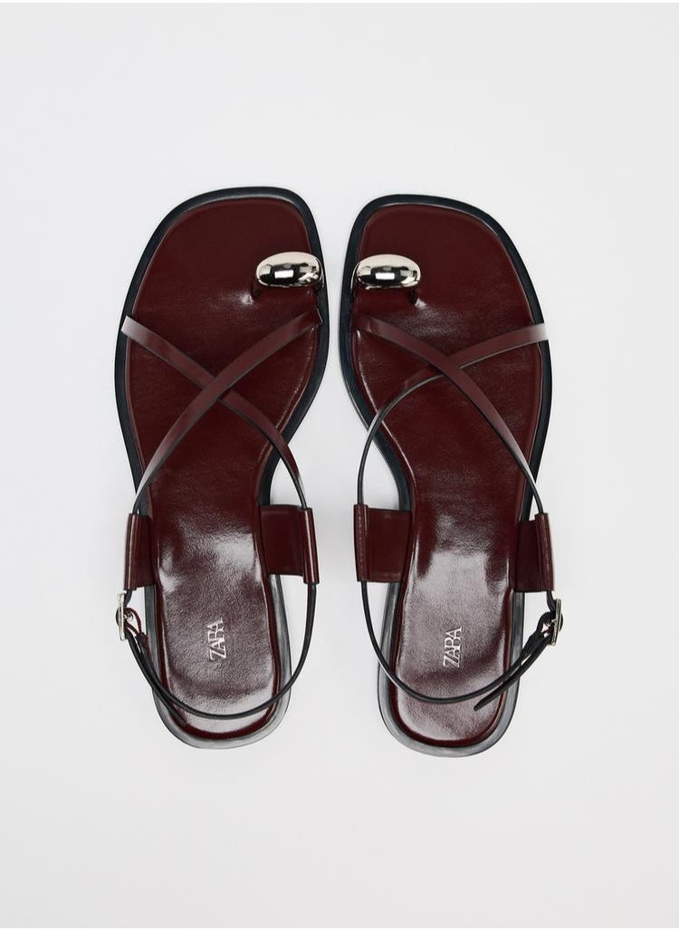Strappy flat slider sandals with metal embellishment