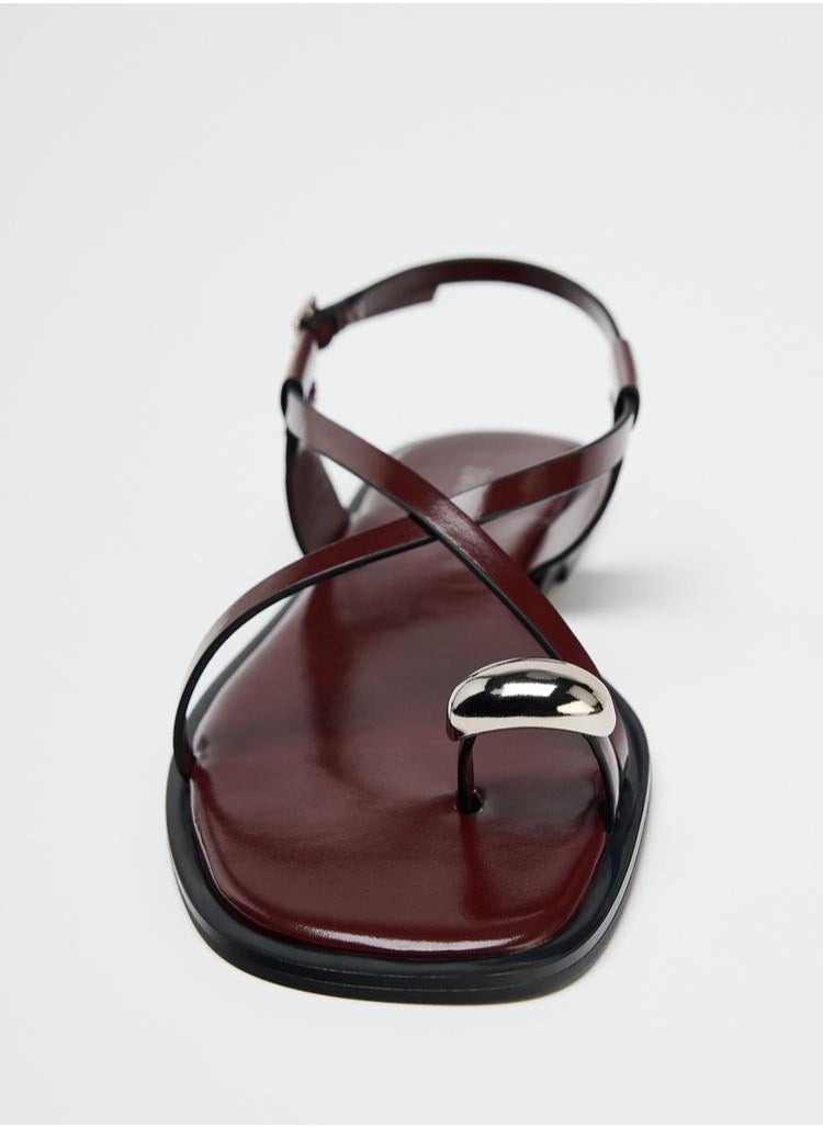 Strappy flat slider sandals with metal embellishment
