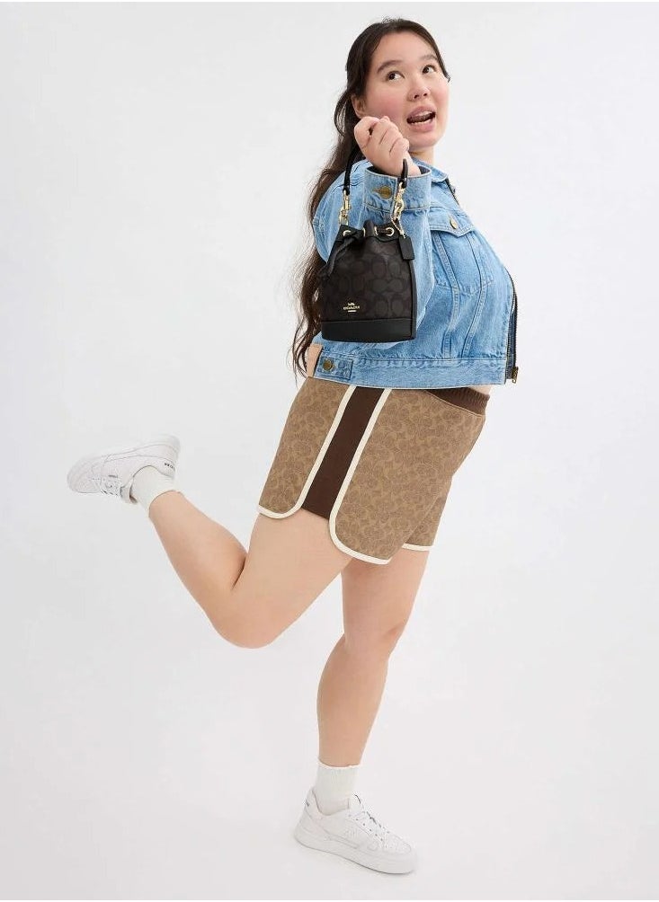 حقيبة دلو صغيرة من قماش Coach Signature