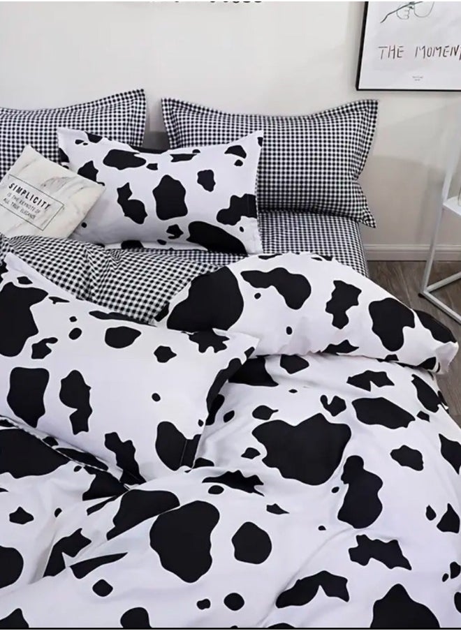 Single 4-piece reversible duvet cover set showcasing a charming black and white cow pattern.