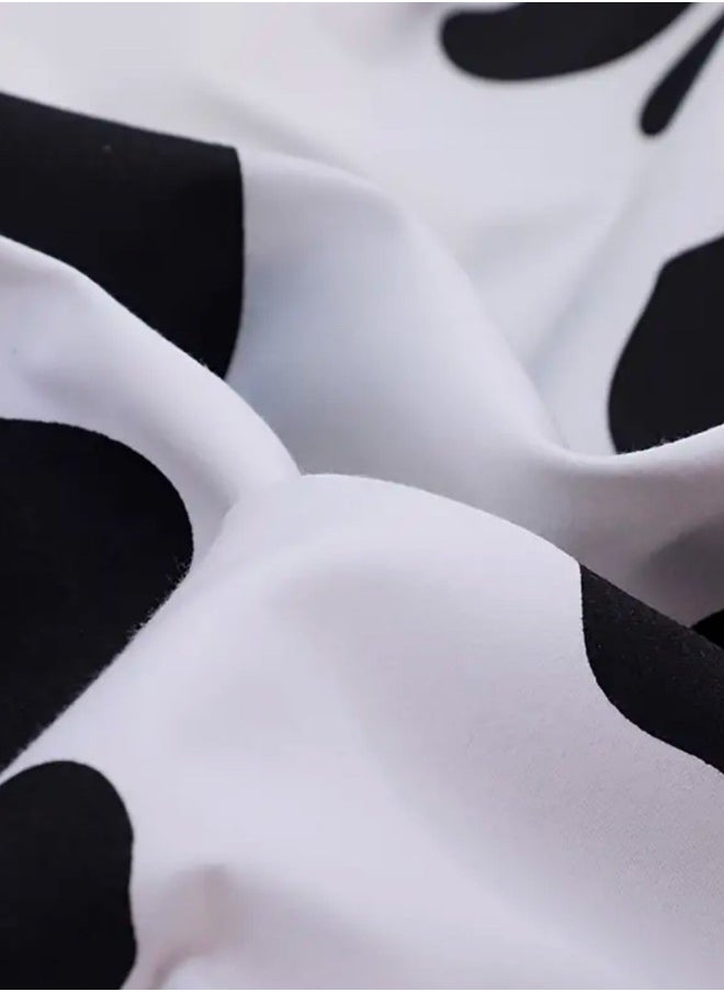 Single 4-piece reversible duvet cover set showcasing a charming black and white cow pattern.