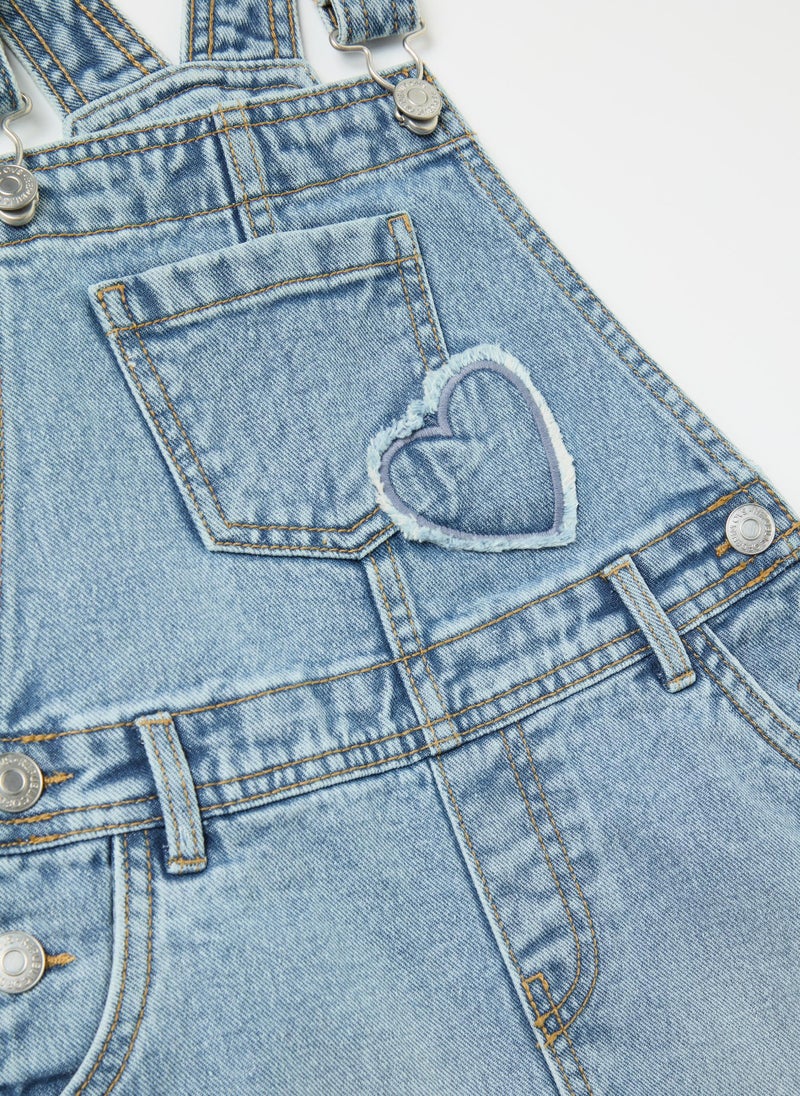 Pinafore in denim with heart embroidery