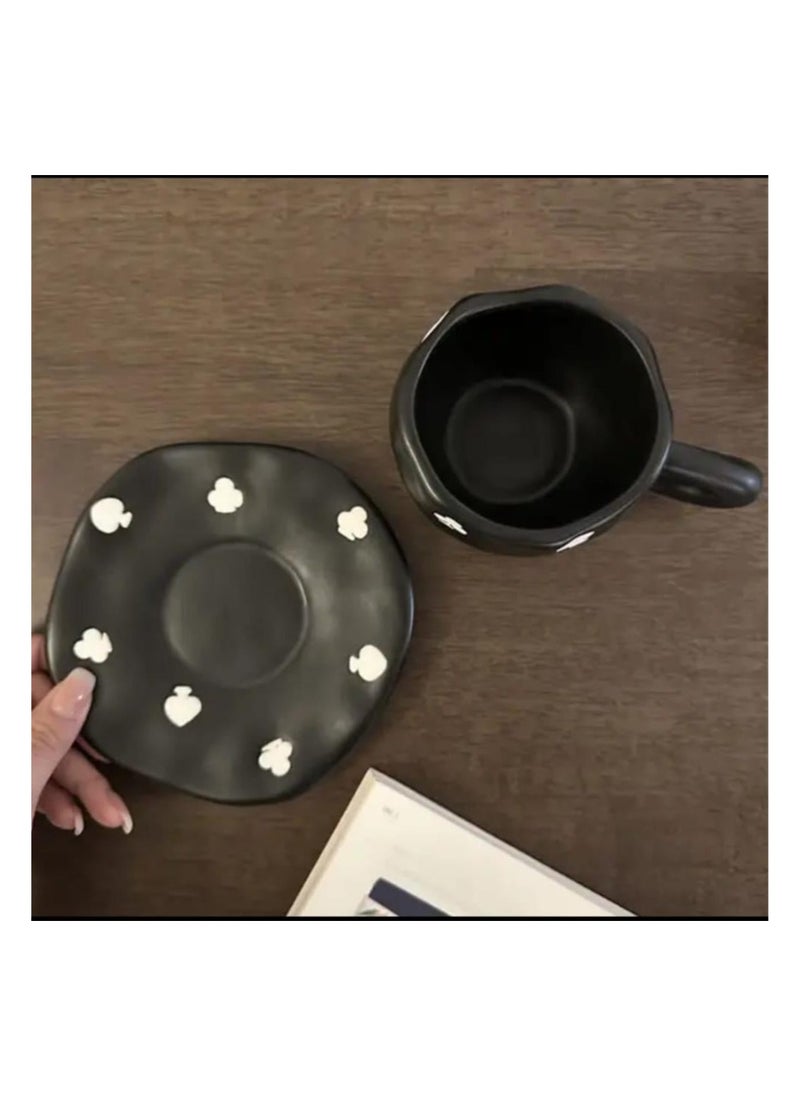 Elegant black ceramic mug with attractive white designs.