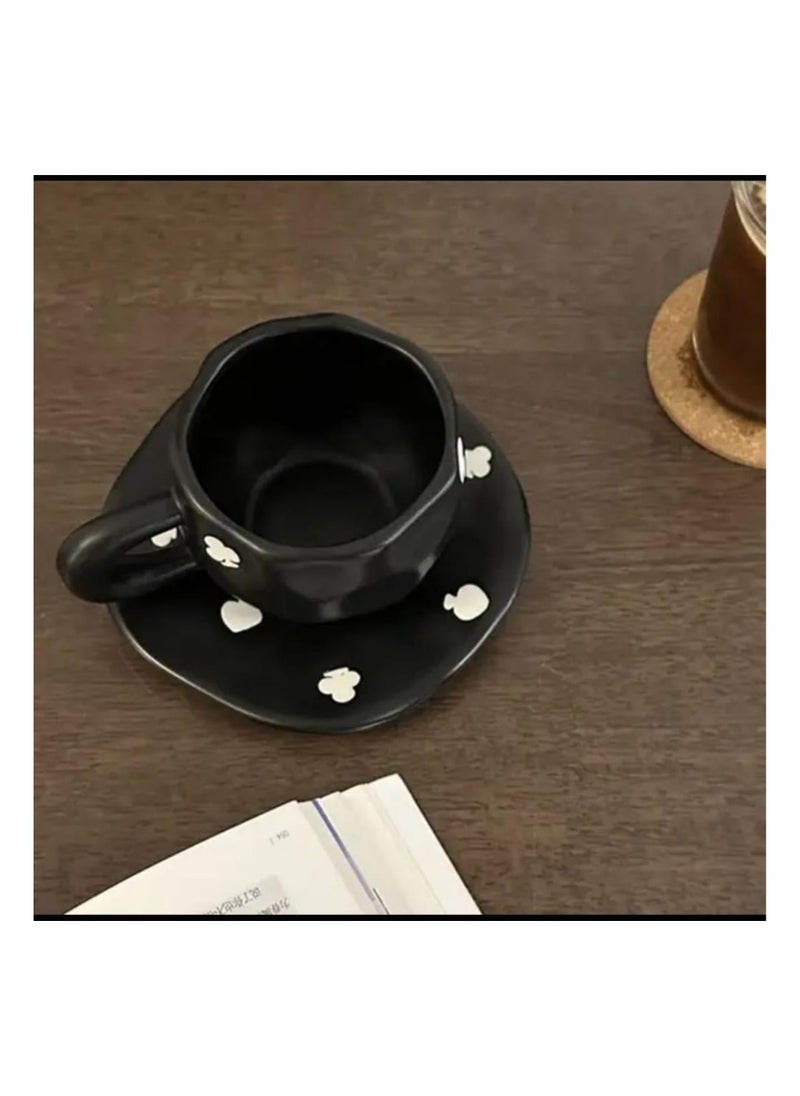 Elegant black ceramic mug with attractive white designs.
