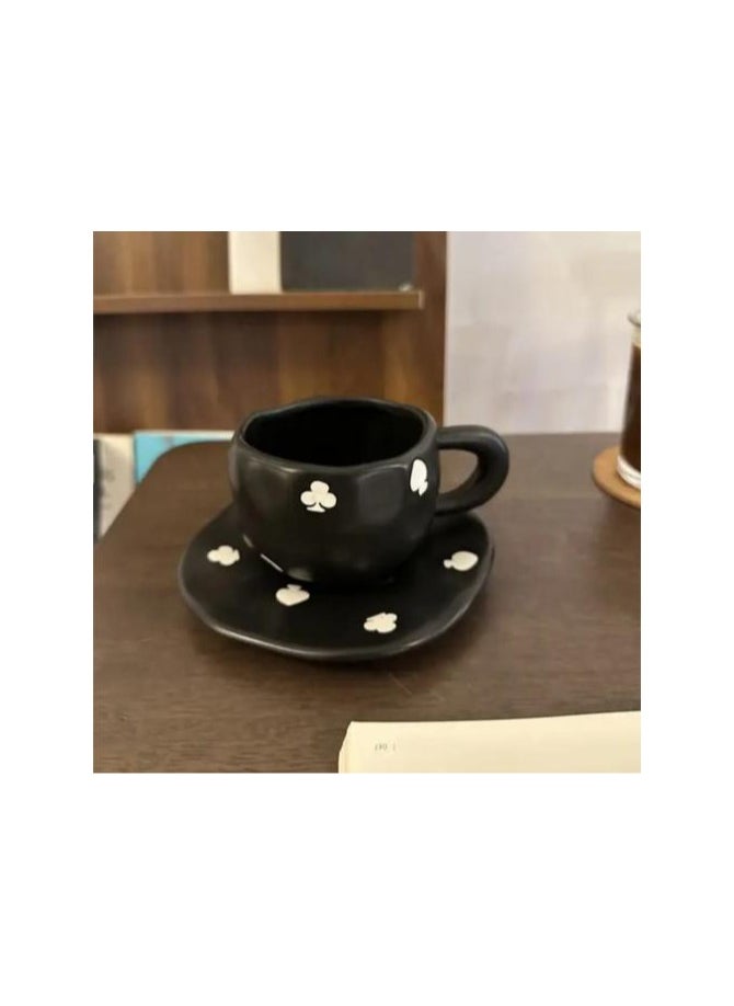 Elegant black ceramic mug with attractive white designs.