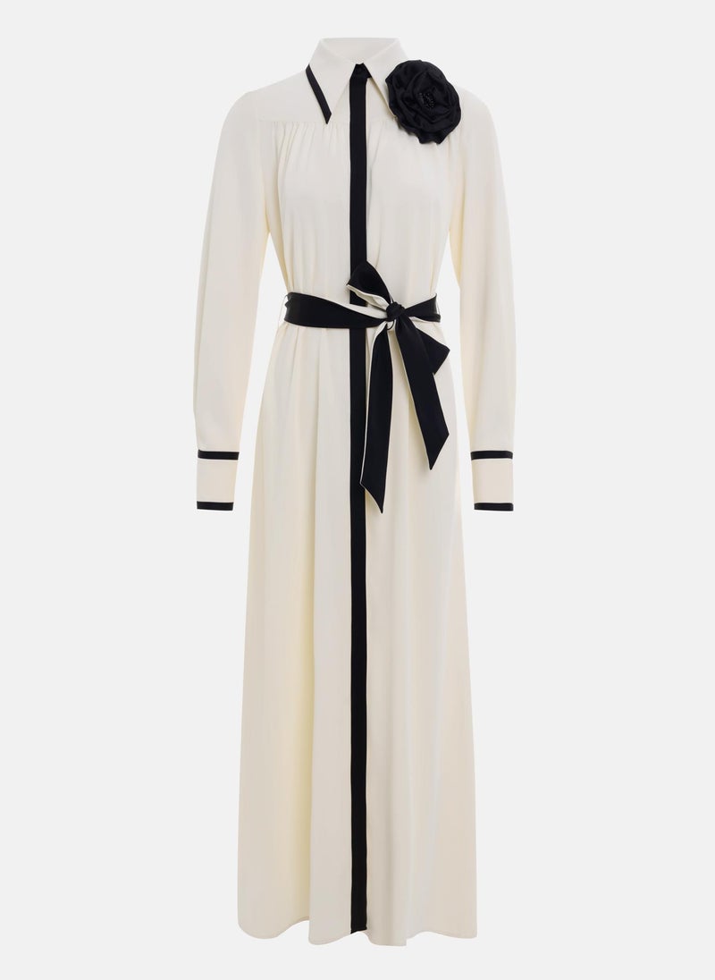 Maxi dress with contrasting inserts and flower brooch