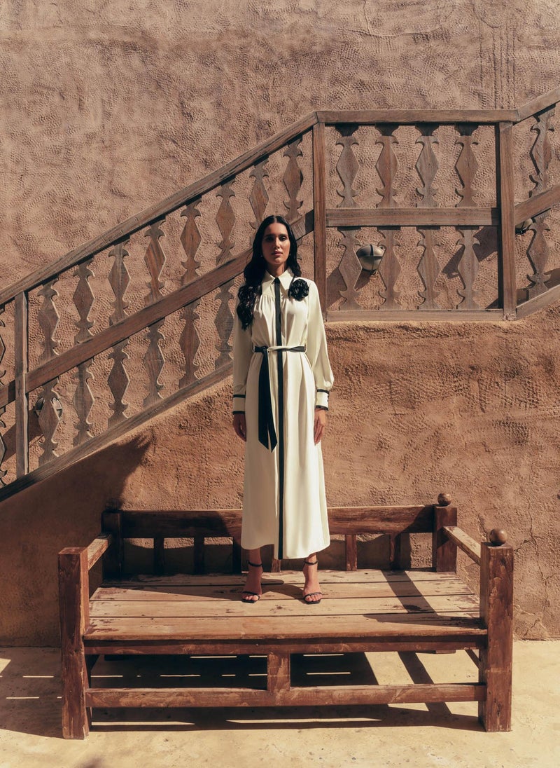 Maxi dress with contrasting inserts and flower brooch