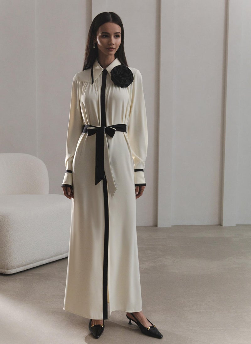 Maxi dress with contrasting inserts and flower brooch