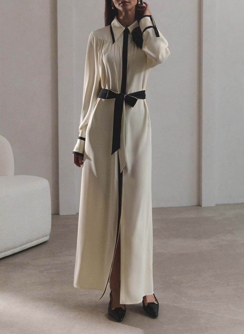 Maxi dress with contrasting inserts and flower brooch